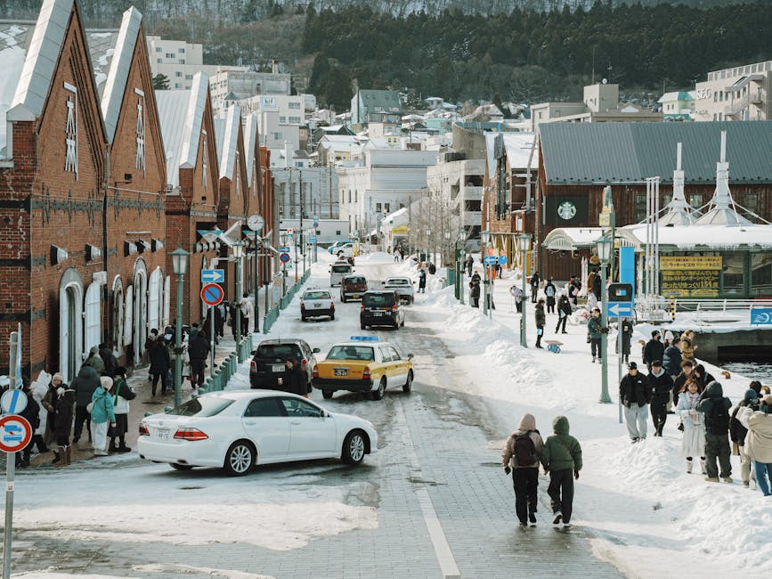 Winter street scene in Hakodate Japan with pedestrians and snow