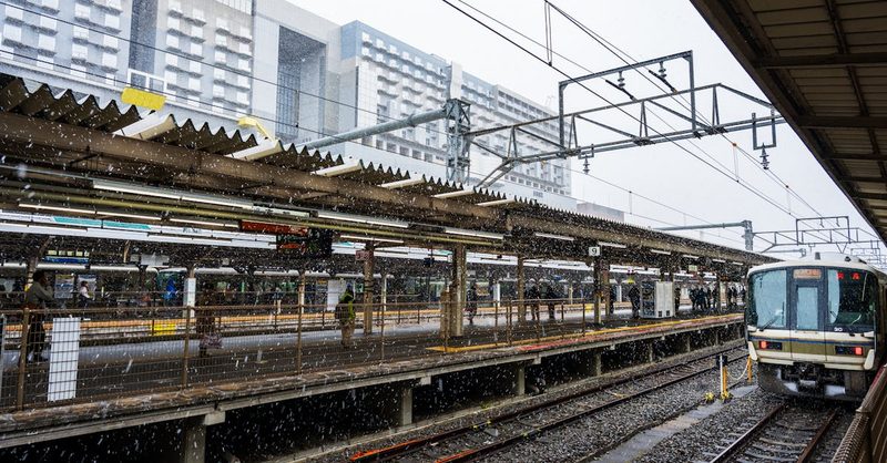 Train traveling through snowy Hokkaido landscape