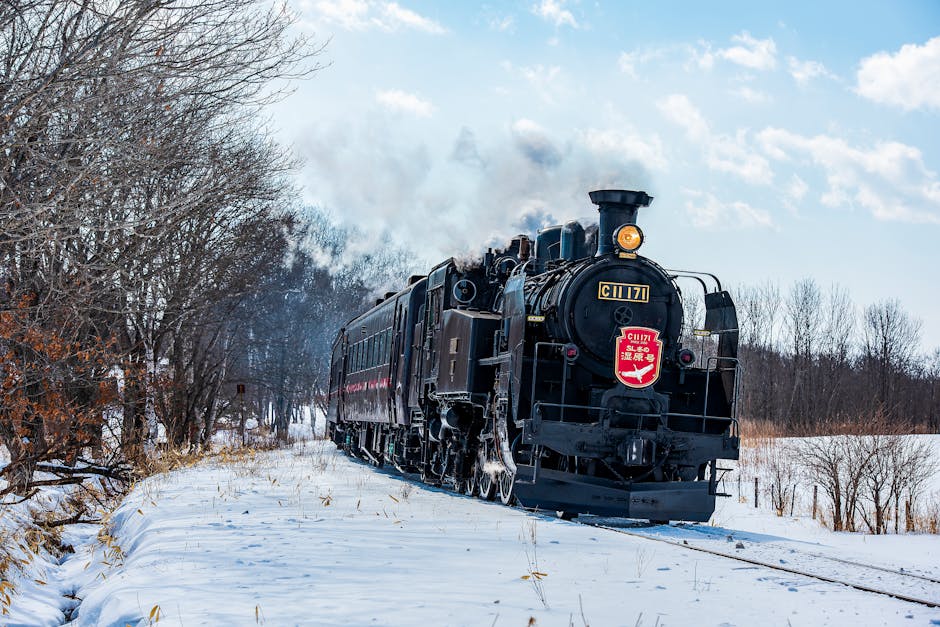 Steam train traveling through snowy Hokkaido landscape