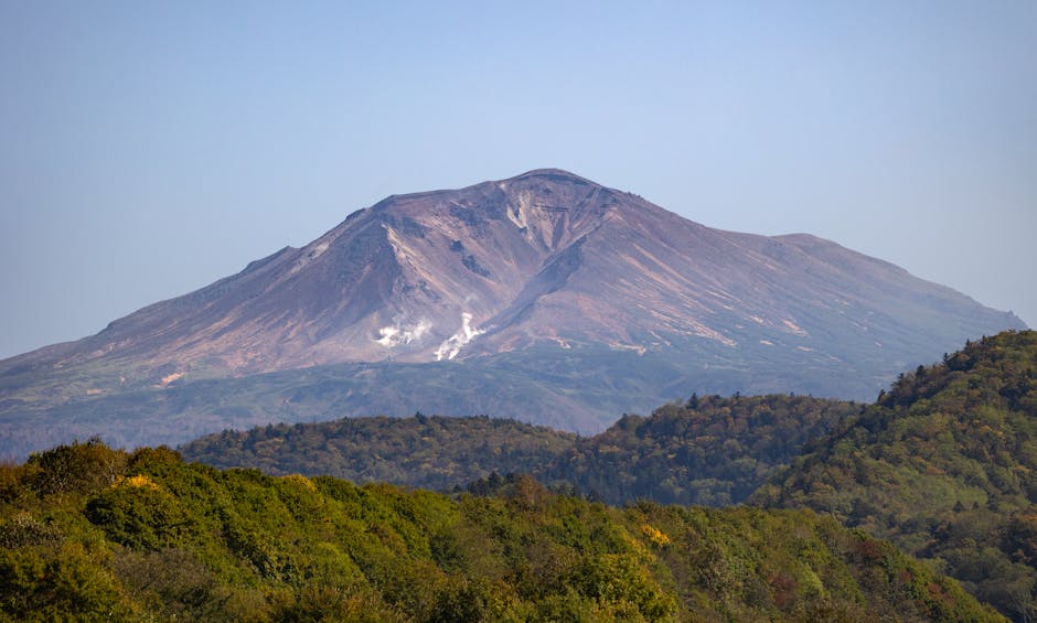 Volcanic mountain surrounded by lush forests in Hokkaido Japan