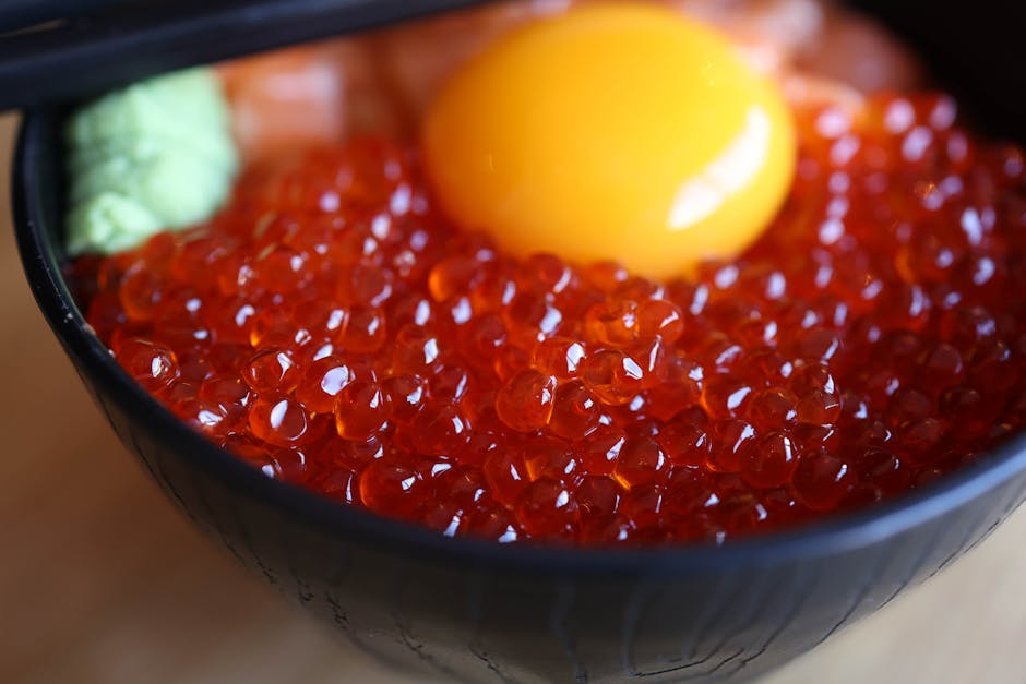 Japanese ikura salmon roe rice bowl with egg yolk and wasabi