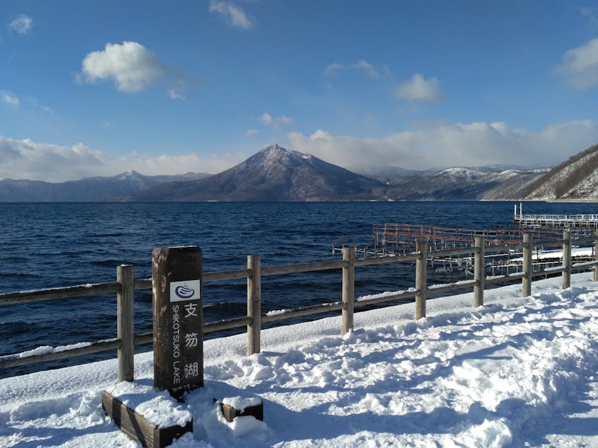 Scenic view of Lake Shikotsu with snow-covered mountains in Hokkaido Japan