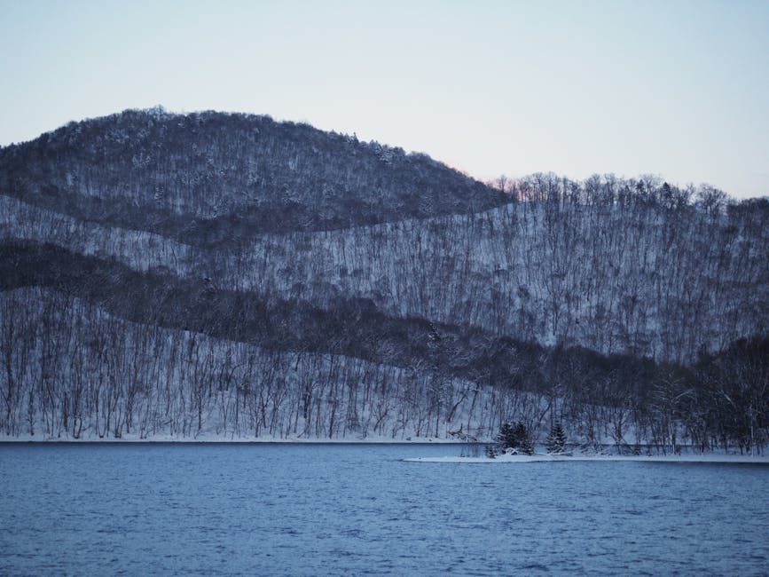 Snow-covered hills by Lake Toya during winter twilight in Hokkaido Japan