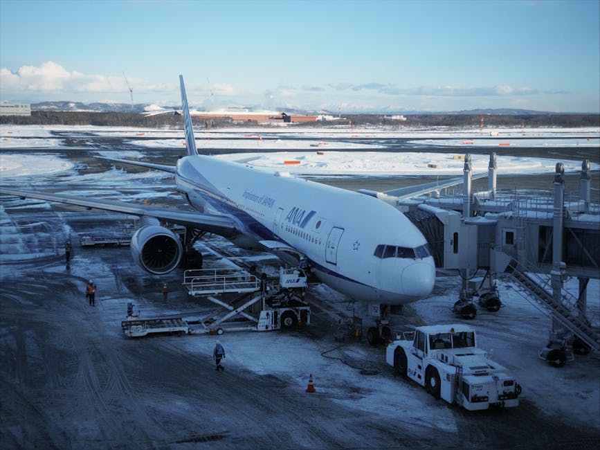 Airplane at New Chitose Airport in winter surrounded by snow in Hokkaido Japan