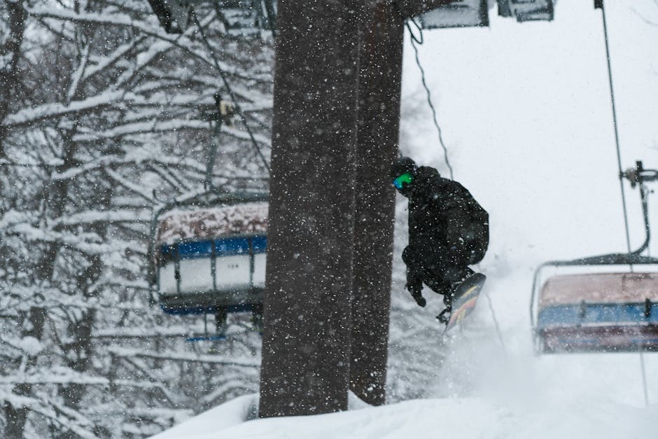 Snowboarder mid-air in deep powder snow in Niseko Hokkaido Japan