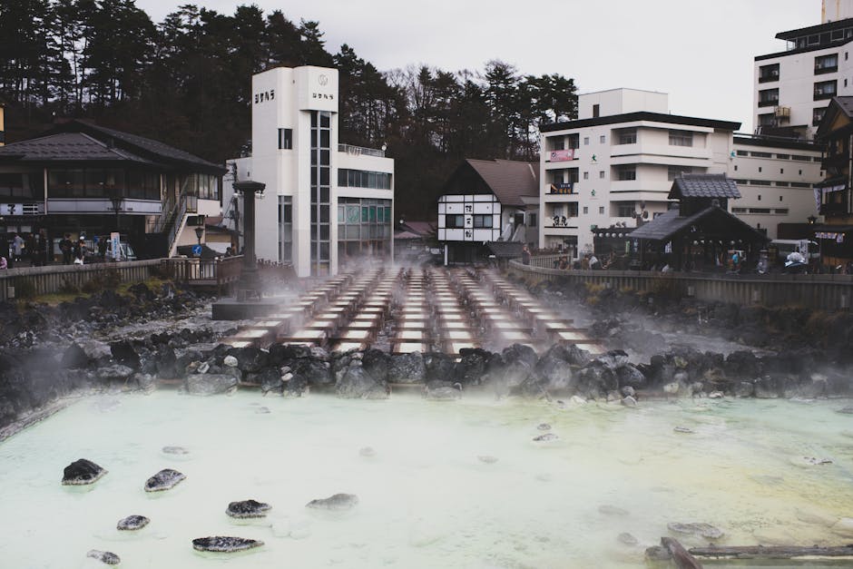 Hot spring town with steam rising from mineral-rich waters in Japan