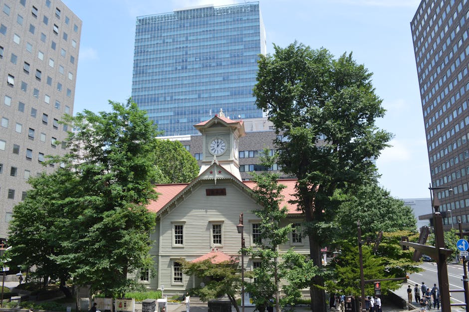 Sapporo clock tower surrounded by modern buildings in Hokkaido Japan