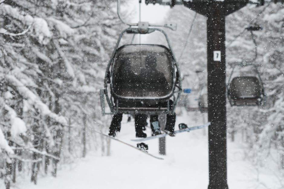 Skiers on a chairlift in a snowy forest in Japan